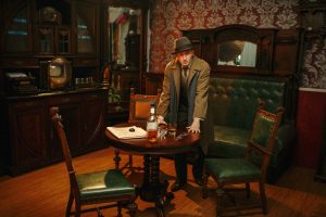 Detective in hat and coat at the crime scene