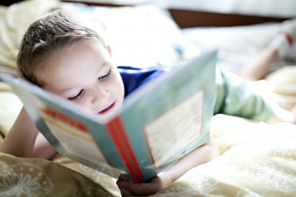 boy engrossed in his book reading